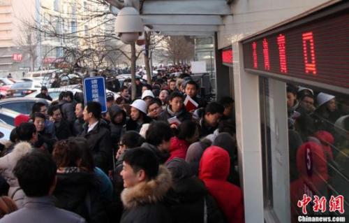 资料图：北京朝阳区房屋登记发证大厅外排队领号准备办理过户手续的市民。 韩海丹 摄